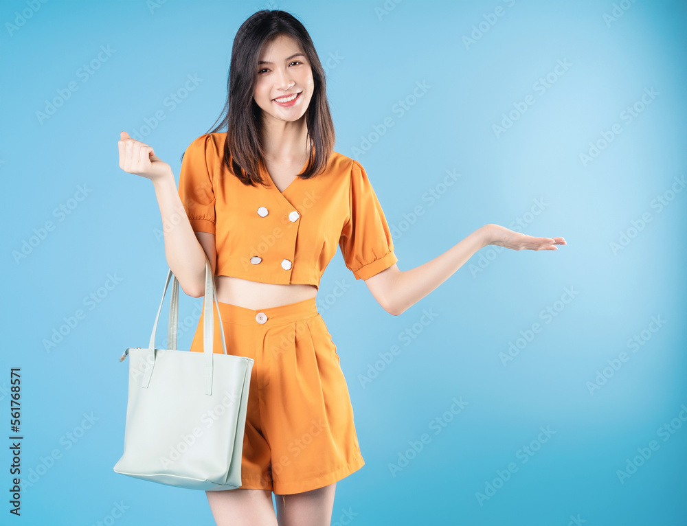 Photo of young Asian woman on blue background