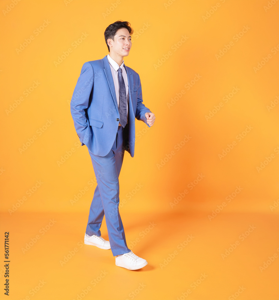 Photo of young Asian businessman on background