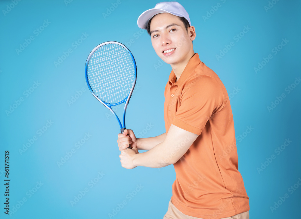 Image of young Asian man holding tennis racket