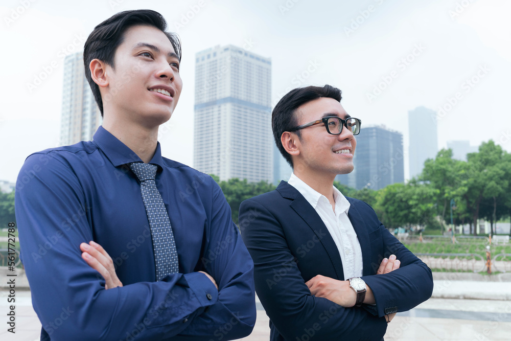 Photo of two Asian businessmans outdoor