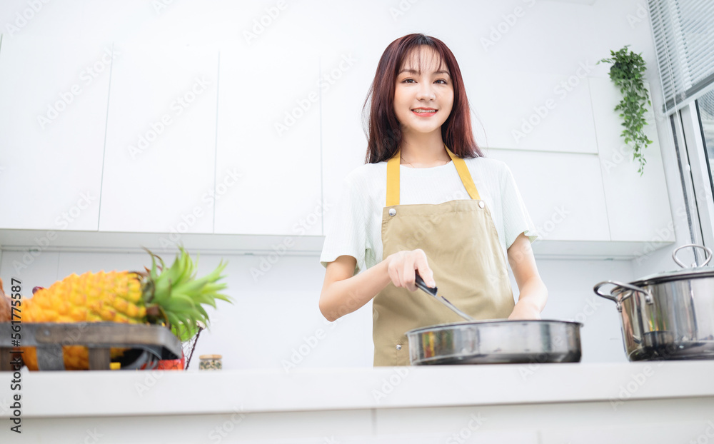 Image of young Asian woman in the kitchen