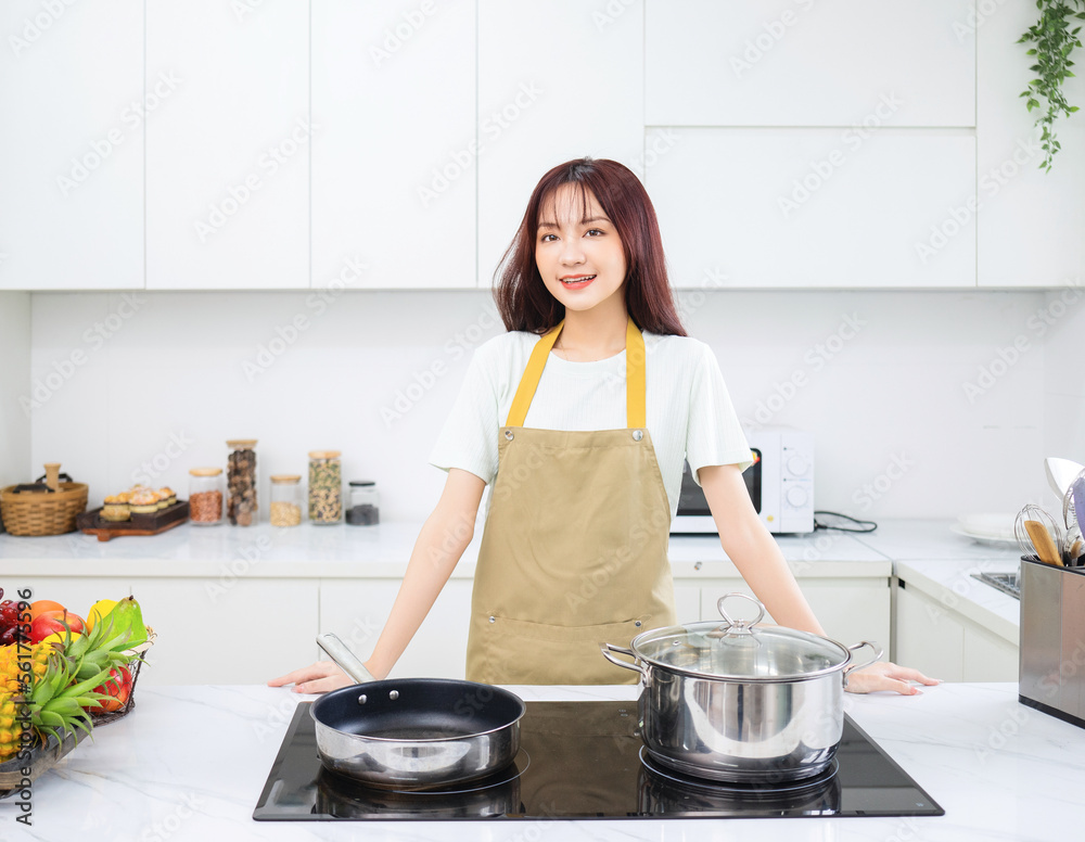 Image of young Asian woman in the kitchen