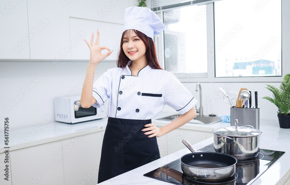 Image of young Asian woman chef in the kitchen