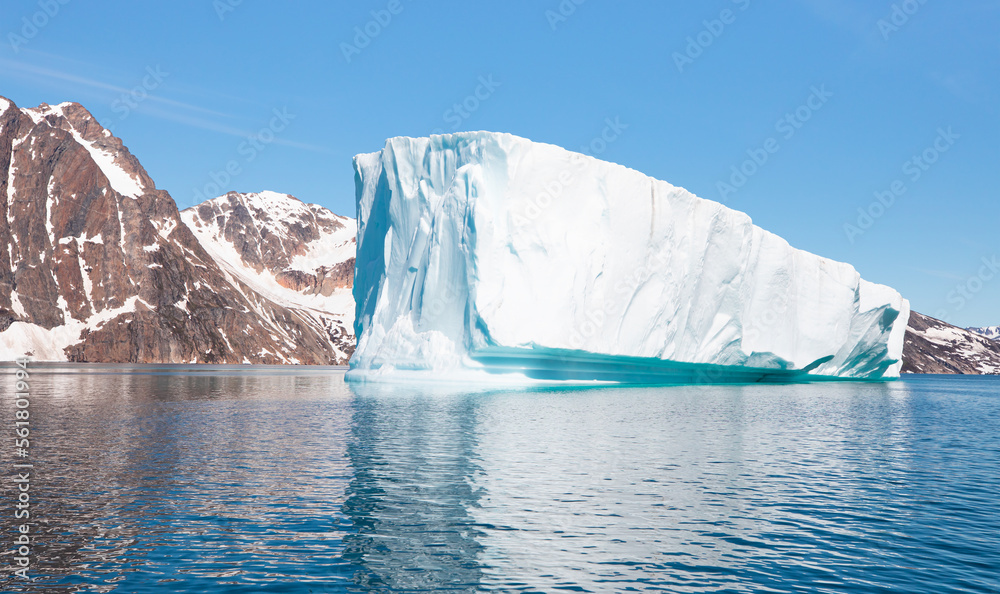 Melting icebergs by the coast of Greenland, on a beautiful summer day - Melting of a iceberg and pou