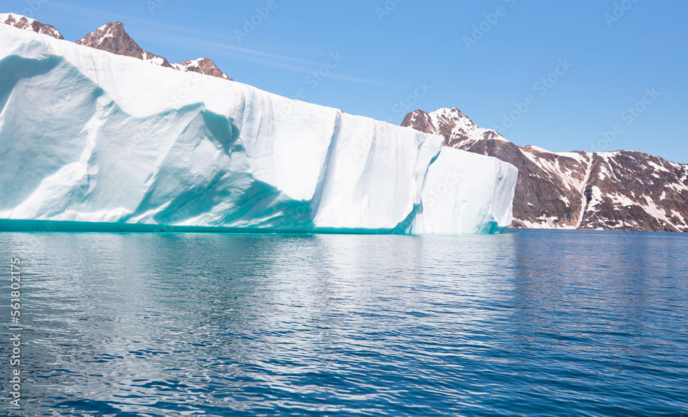 Melting icebergs by the coast of Greenland, on a beautiful summer day - Melting of a iceberg and pou