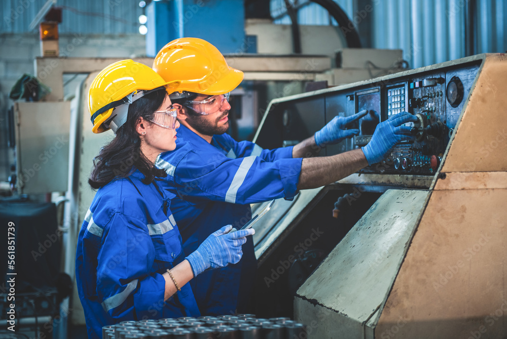 Portrait of Heavy industry workers working on the metal fabrication process by operating a lathe at 