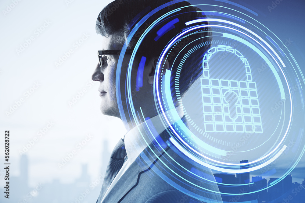 Portrait of young european businessman with abstract padlock button on city background with mock up 