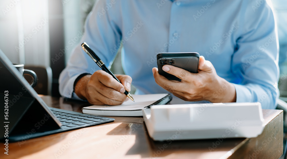 businessman hand working with new modern computer and writing on the notepad strategy diagram as con