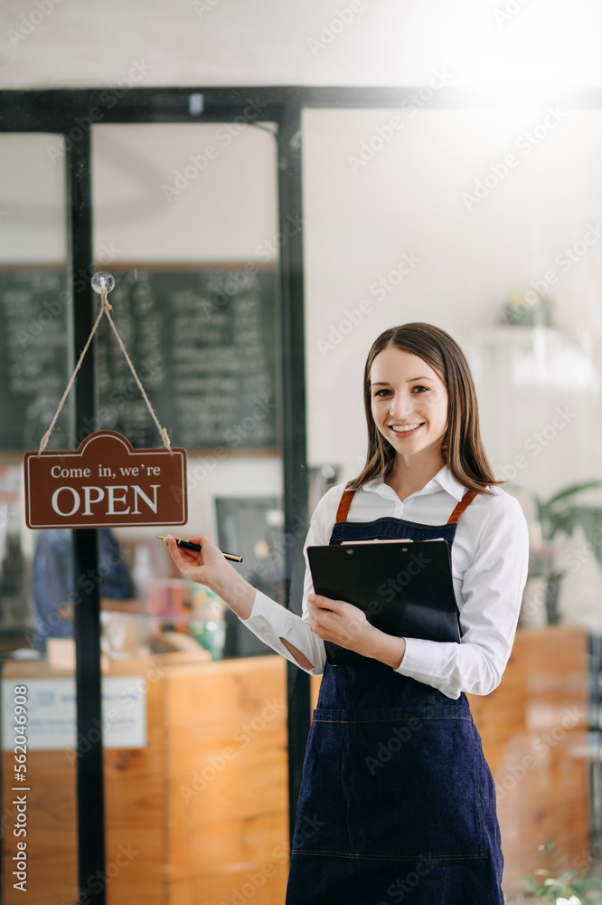 Startup successful small business owner sme woman stand with tablet  in cafe restaurant. woman baris