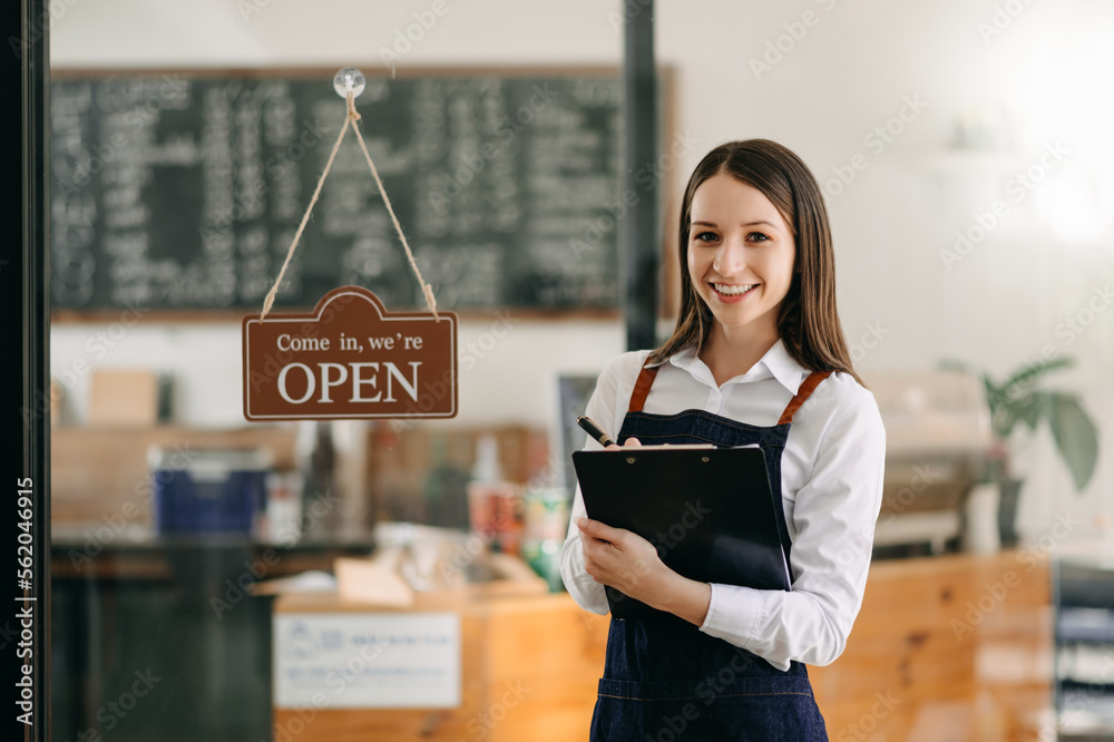 Startup successful small business owner sme woman stand with tablet  in cafe restaurant. woman baris