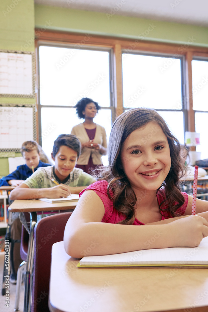 Happy, students and portrait of girl in classroom with notebook for lesson notes and knowledge. Scho