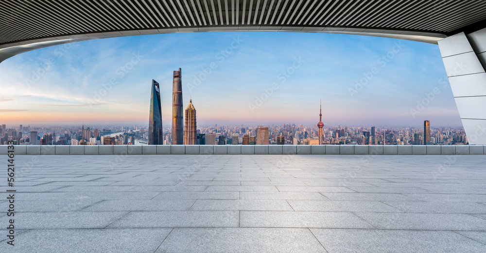 Empty square floor and bridge with city skyline at sunrise in Shanghai, China.