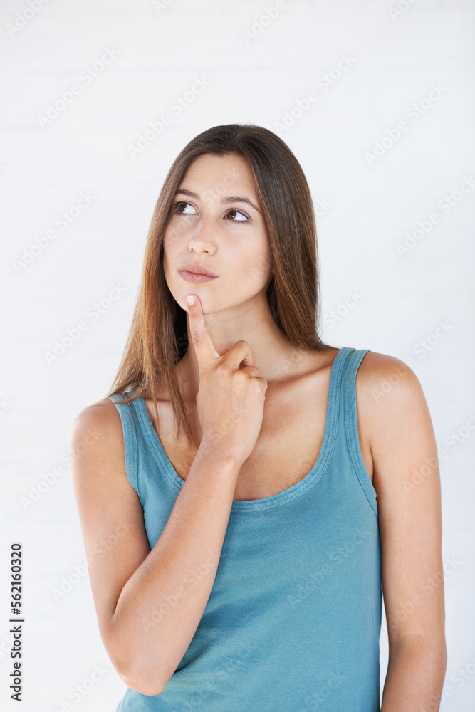 Hand, thinking and woman with idea in studio for vision or decision against white background space. 