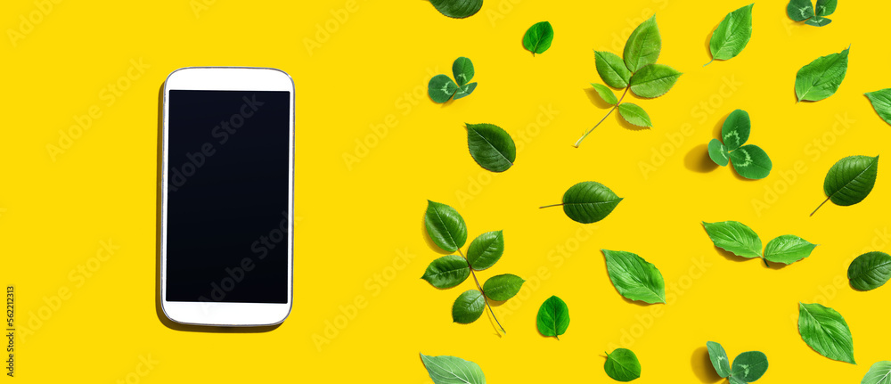 White smartphone with green leaves