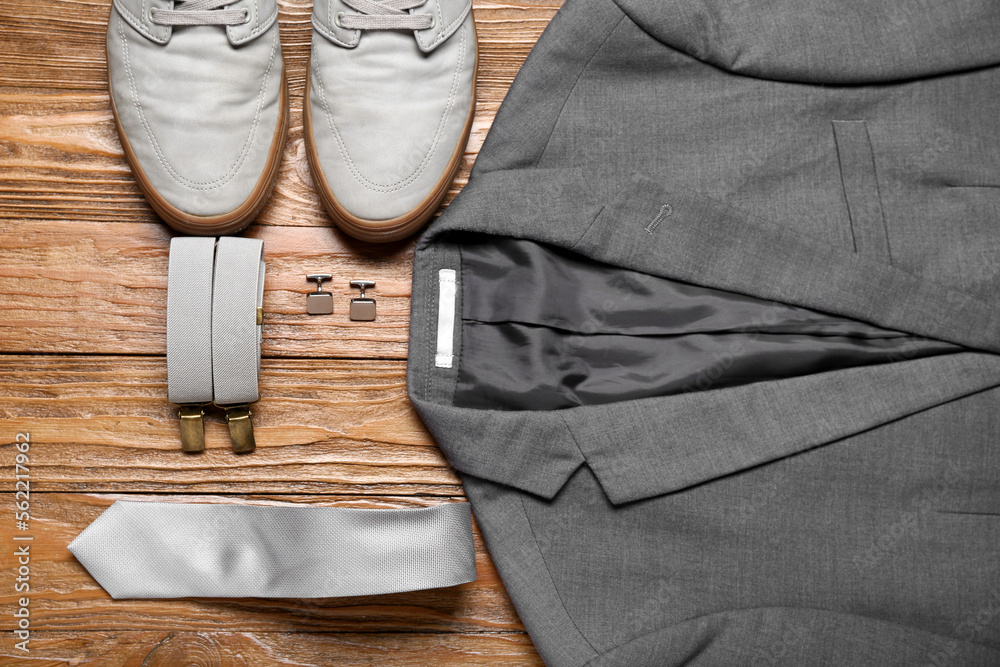 Male clothes, shoes and stylish accessories on wooden background