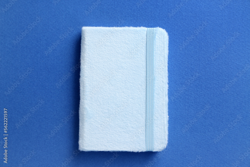 Stylish notebook on blue background