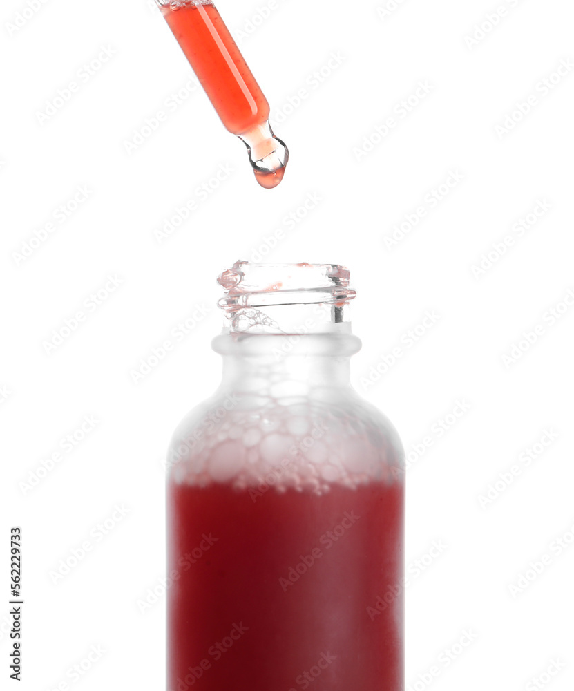 Dripping of serum from pipette into glass bottle on white background, closeup