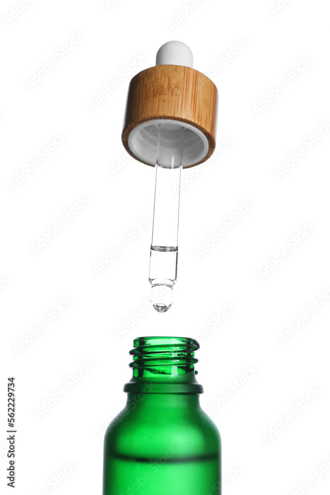 Dripping of healthy serum into bottle on white background, closeup