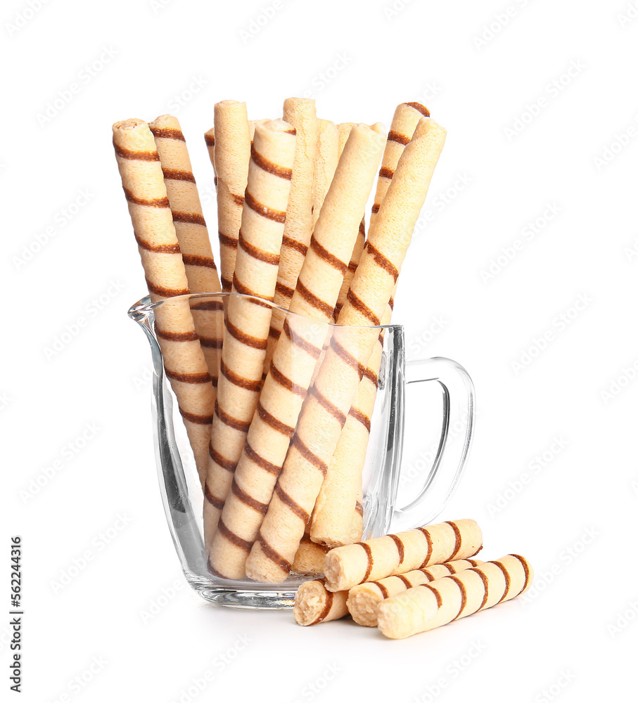 Jug of tasty wafer rolls on white background