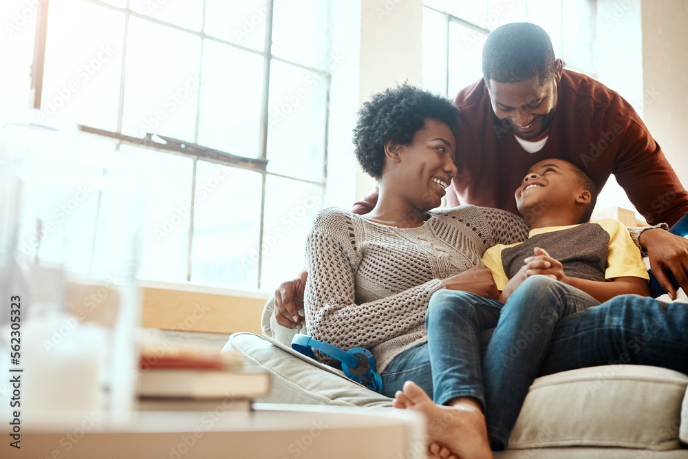 Black family, happy and relax on sofa with boy and parents, hug and laughing in their home together.