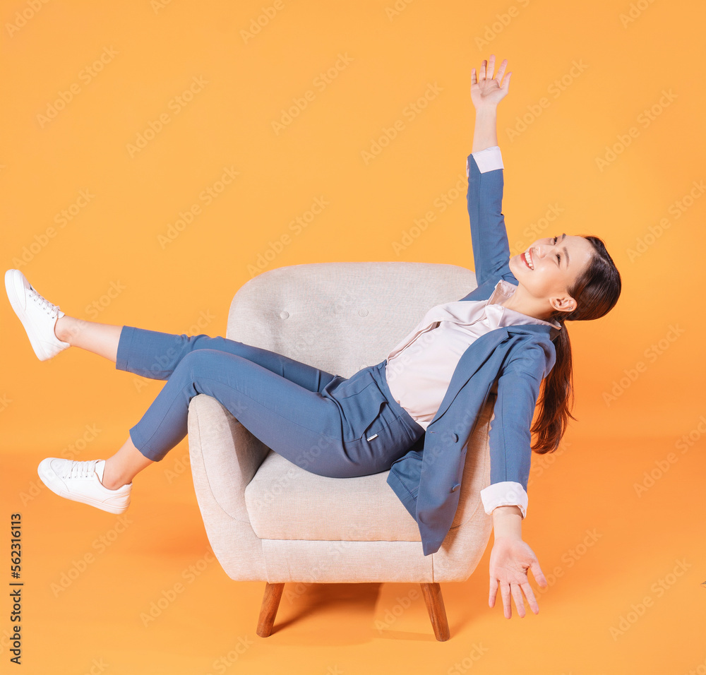 Photo of young Asian businesswoman sitting on armchair