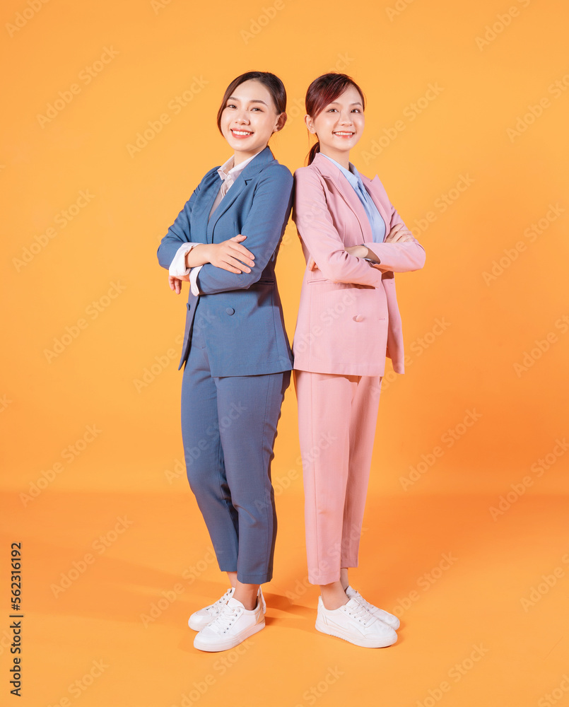 Photo of two young Asian businesswoman on background