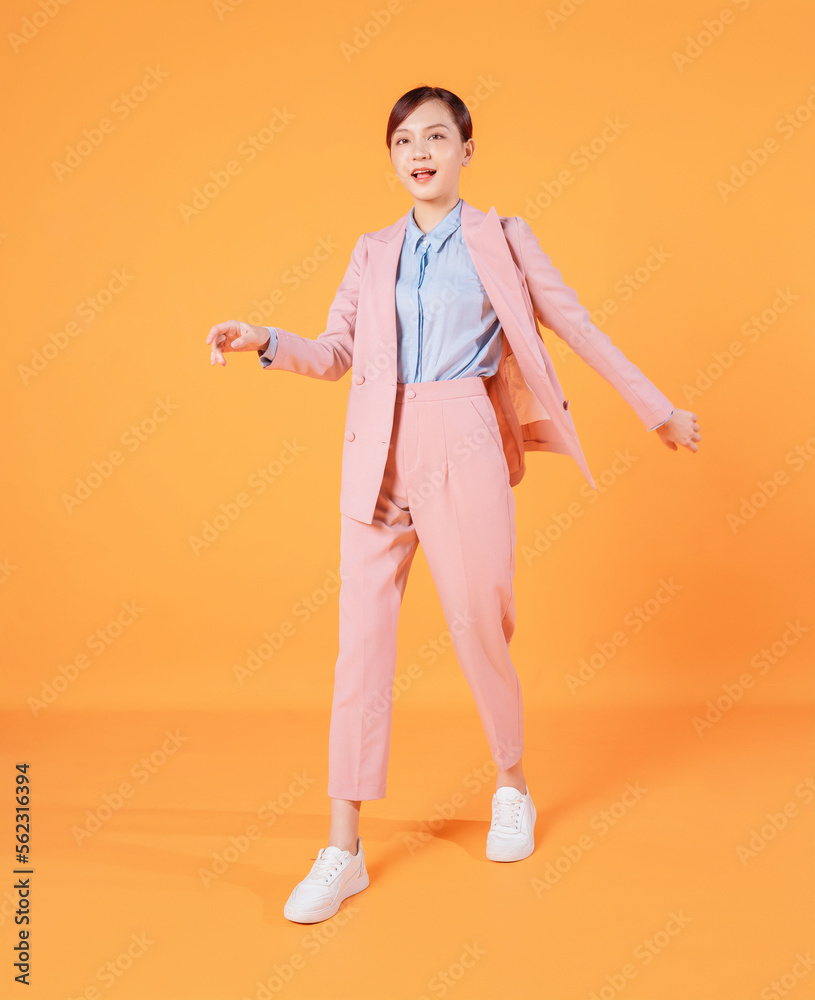 Young Asian businesswoman standing on background