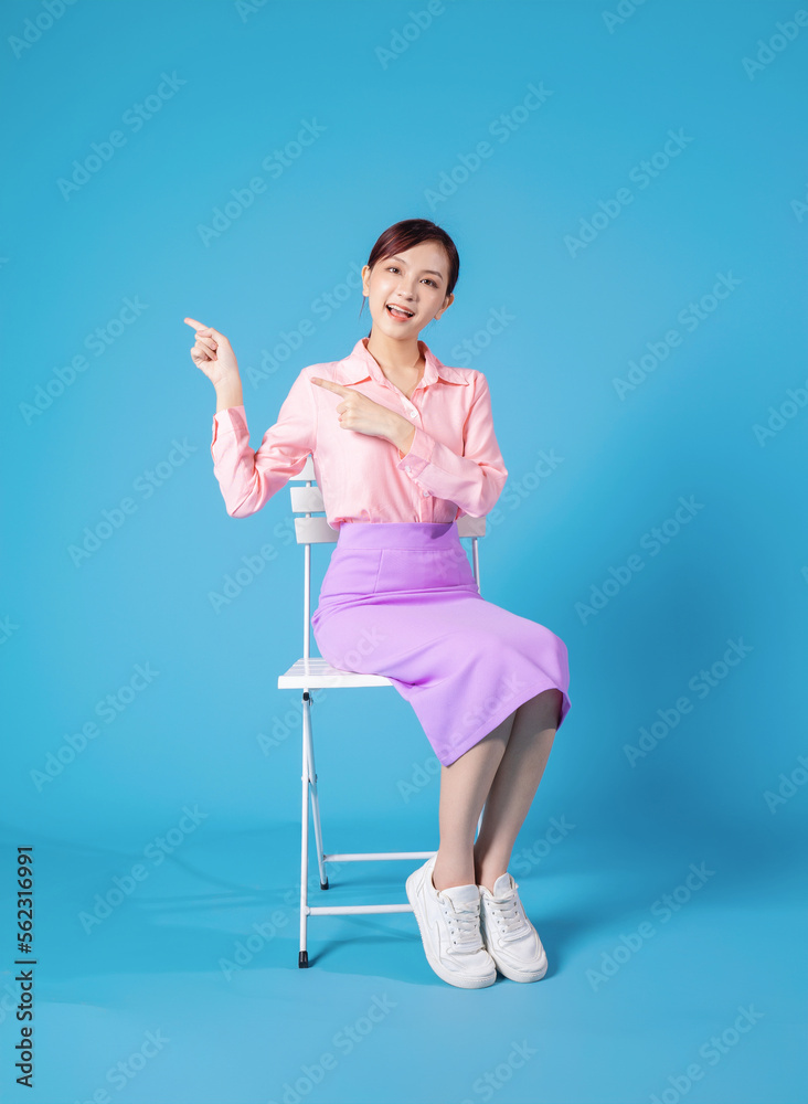 Photo of young Asian businesswoman sitting on chair