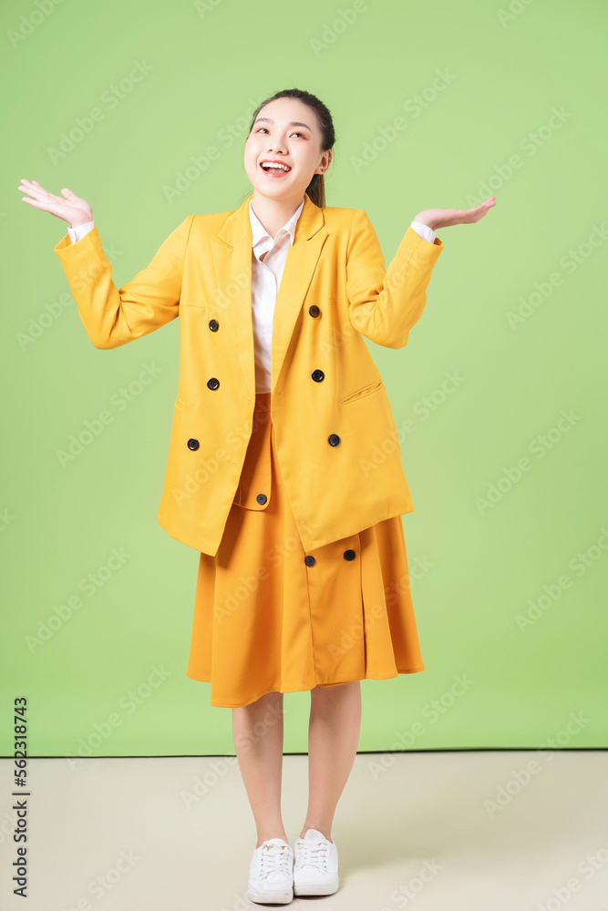 Image of young Asian businesswoman on green background