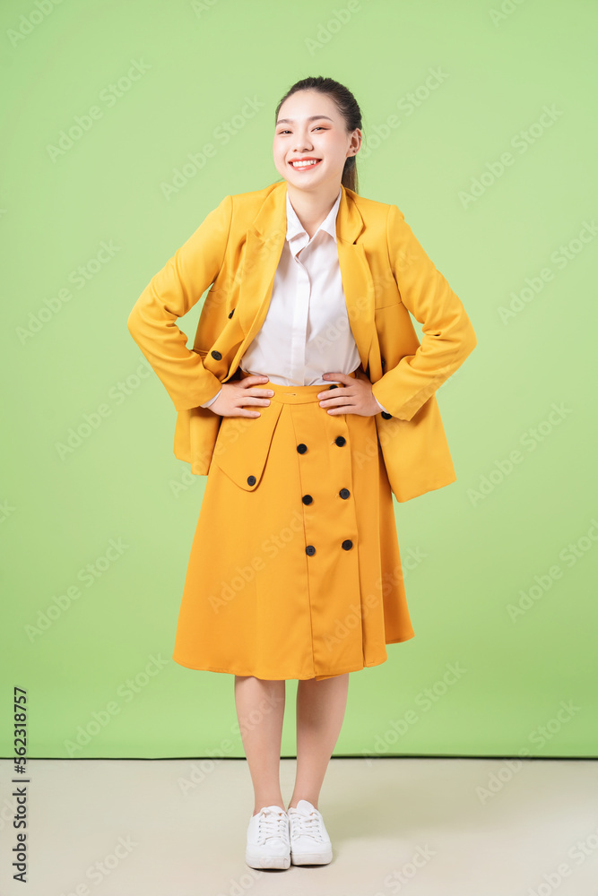 Image of young Asian businesswoman on green background