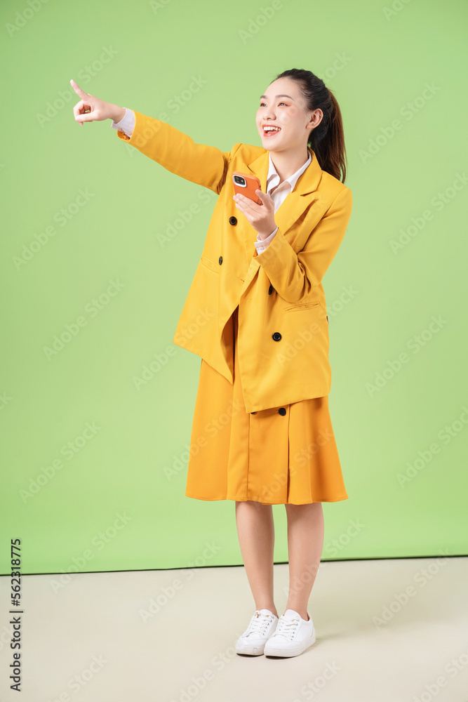 Image of young Asian businesswoman on green background