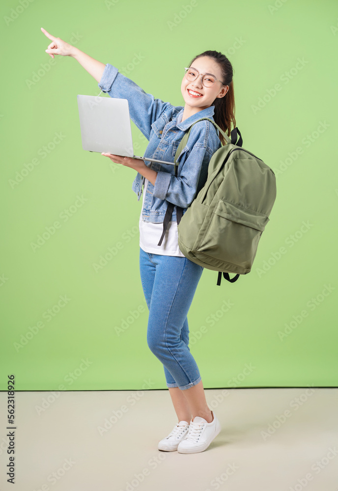 Photo of young Asian college girl on green background