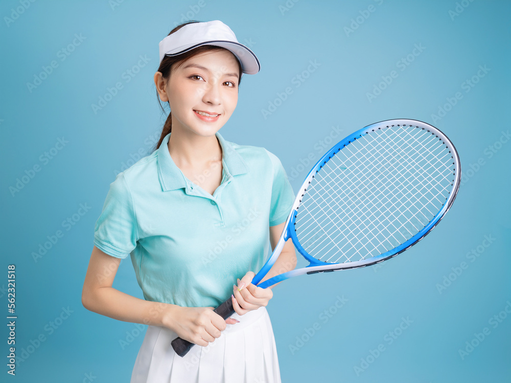 Image of young Asian girl playing tennis