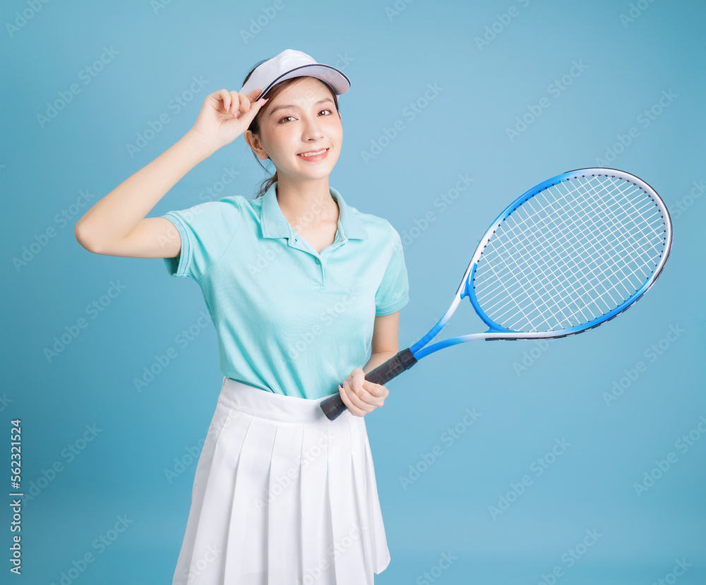 Image of young Asian girl playing tennis