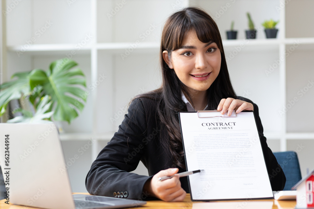 Businesswoman, real estate agent holding contract documents explaining legal agreement, mortgage, re