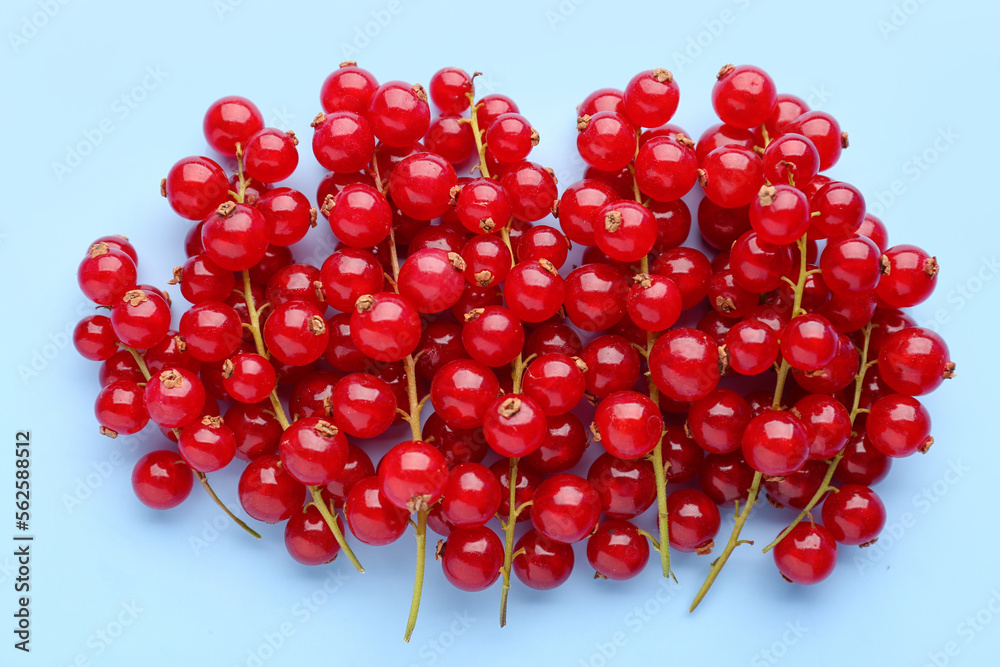 Heap of ripe red currant on color background