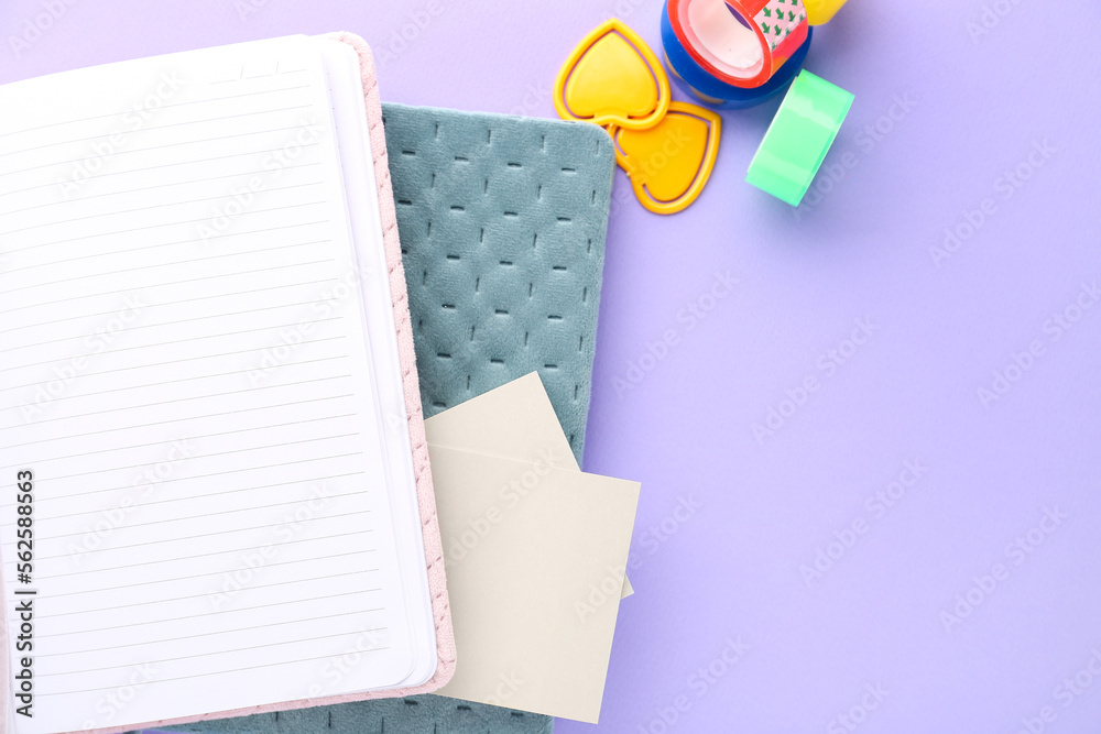 Different stationery on lilac background, closeup