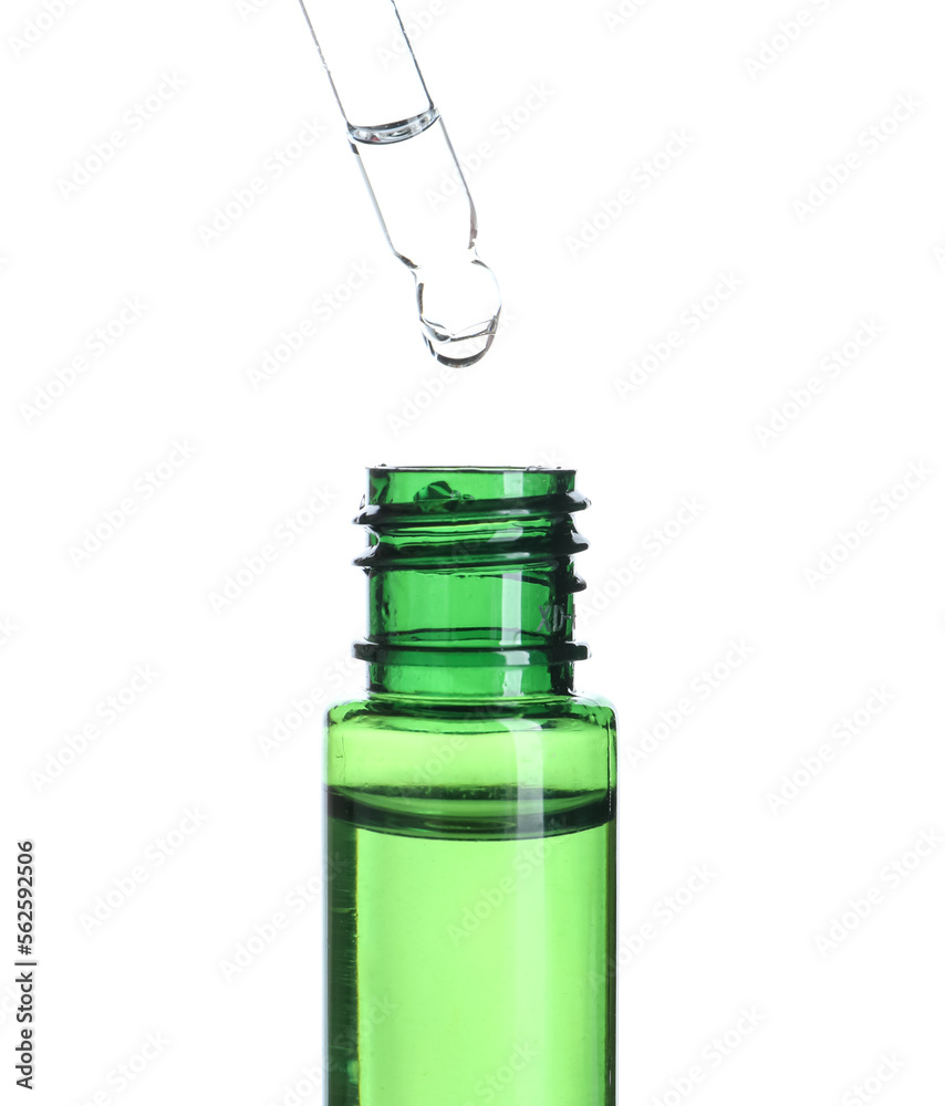 Dripping of natural serum into bottle on white background, closeup