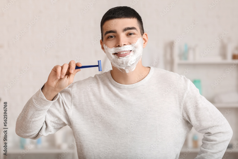 Morning of young man shaving in bathroom