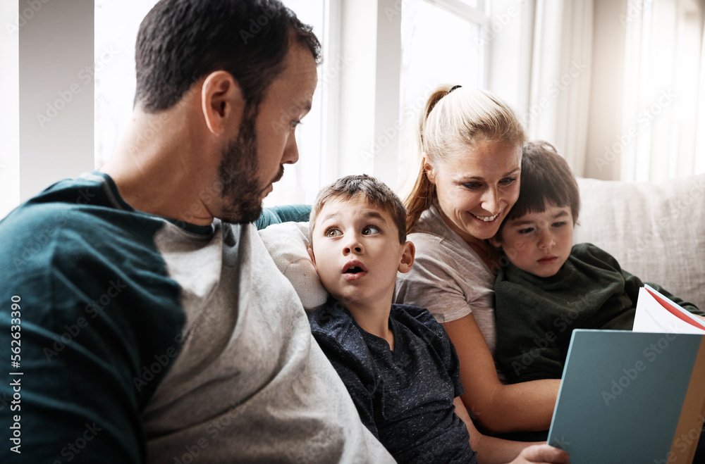 Man, woman and kids on sofa with book learning to read at storytelling time in living room of home. 