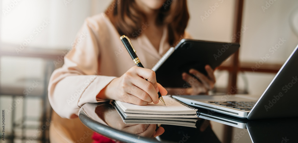 businesswoman hand working with new modern computer and writing on the notepad strategy diagram as c