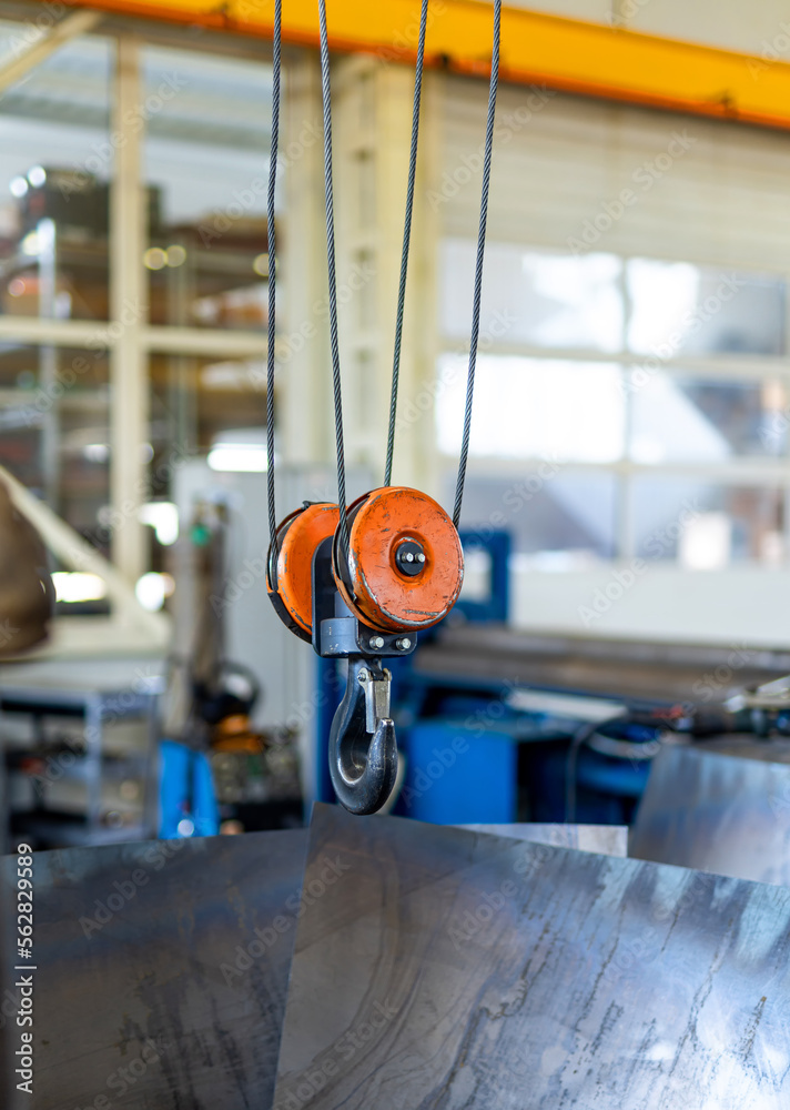 Indoor factory construction lifting. Metal factory hook crane.