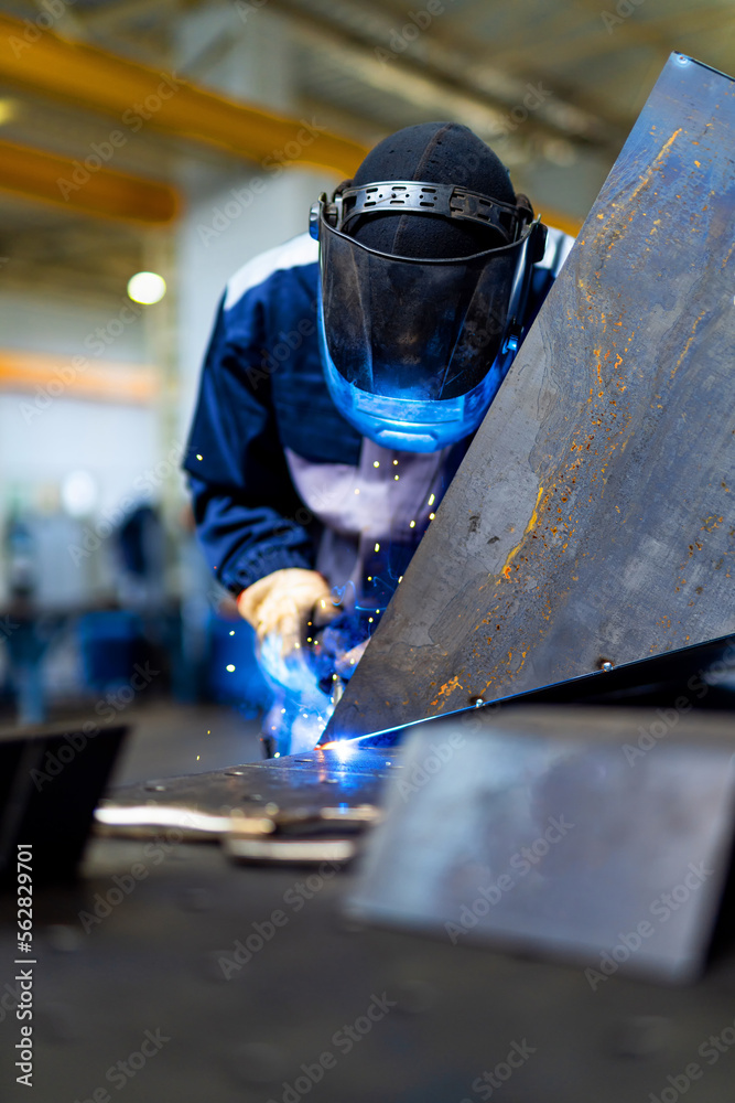 Metal welding specialist. Engineering welder working in metal factory.