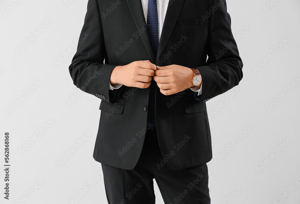 Businessman in suit on light background