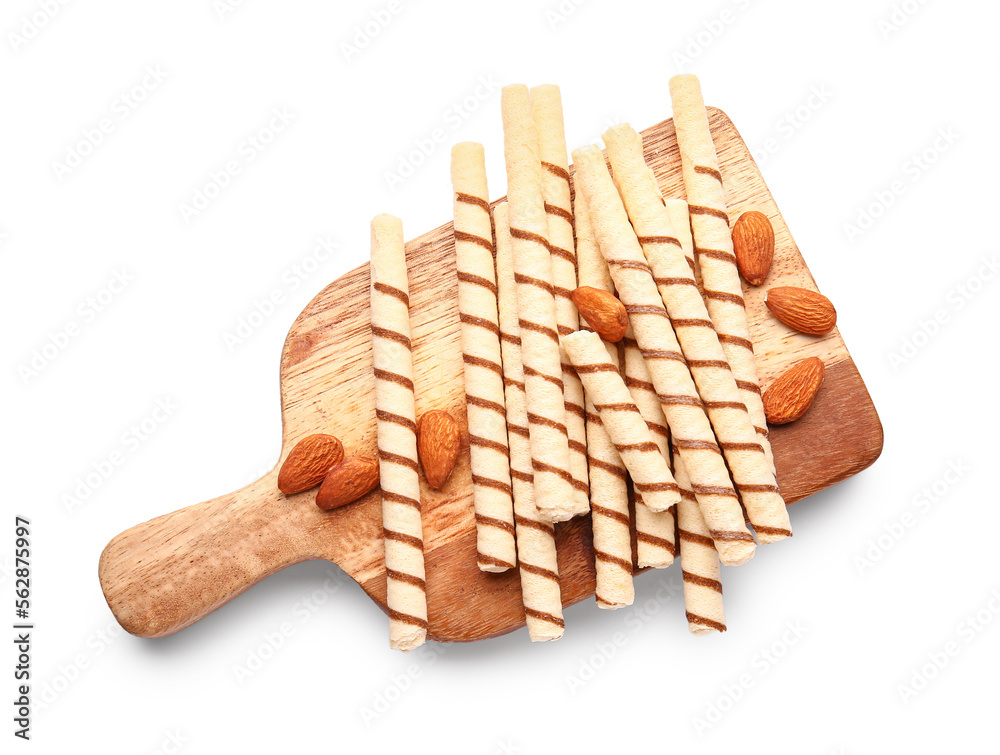 Cutting board with tasty wafer rolls and almonds isolated on white background