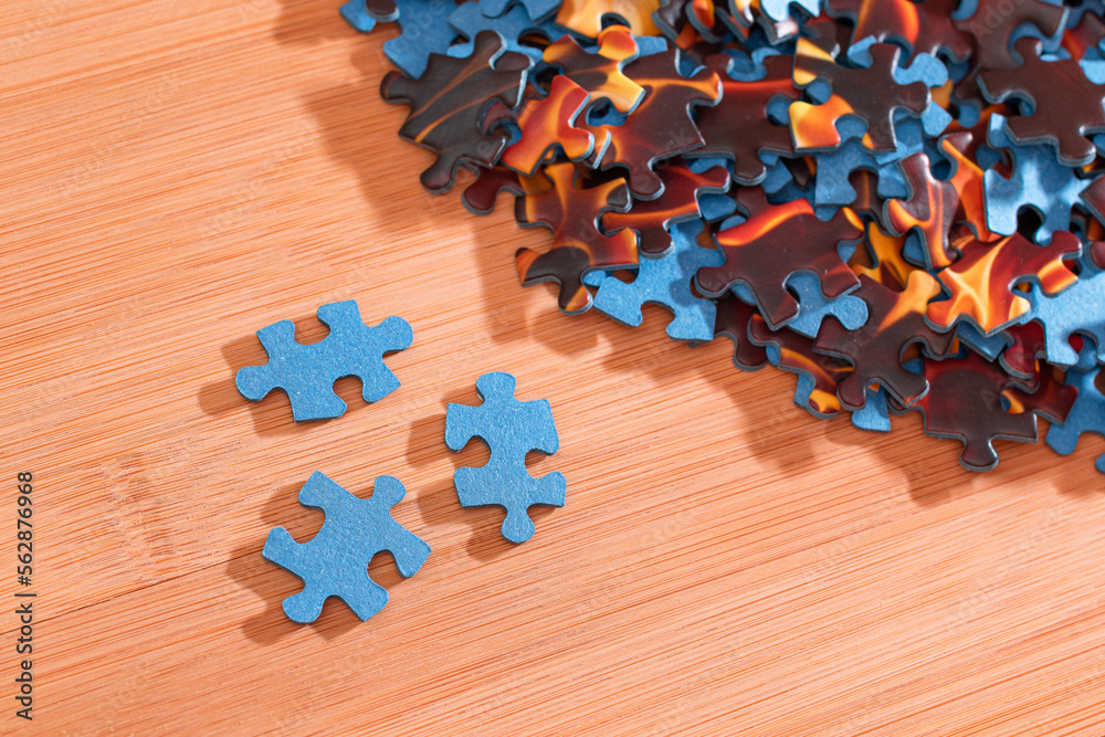 Colorful Peaces of a Mixed Jigsaw Puzzle Lie on the Wooden Table - Strategy and Solving Problem Conc