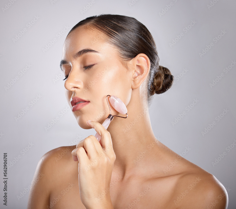 Rose quartz, face roller and woman skincare of a model relax from facial spa treatment. Isolated, st