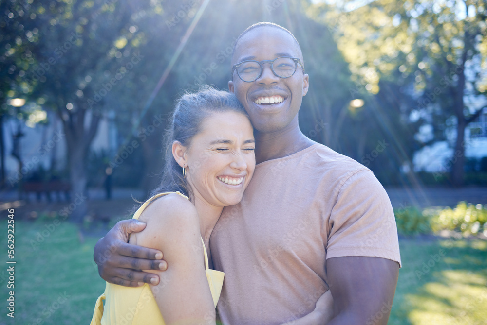 Happy interracial couple, hug and laughing in joy for bonding relationship together in the park. Man