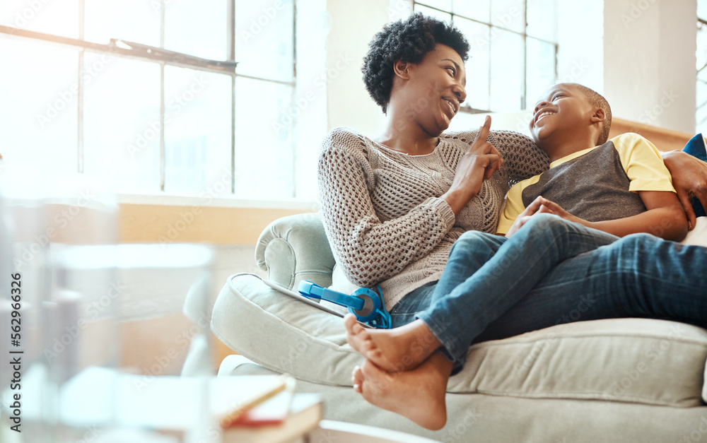 Black family, son and mother relax on a sofa, laugh and happy while bond in their home together. Mom