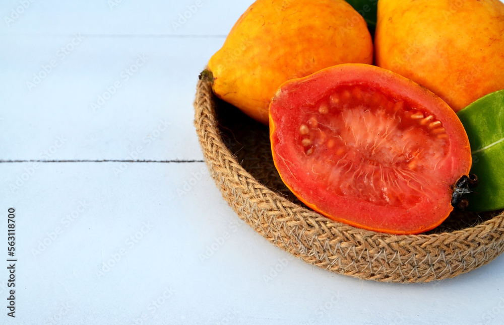 Ripe guava fruits in the basket on light background. Psidium guajava.Tropical fruits,healthy food or